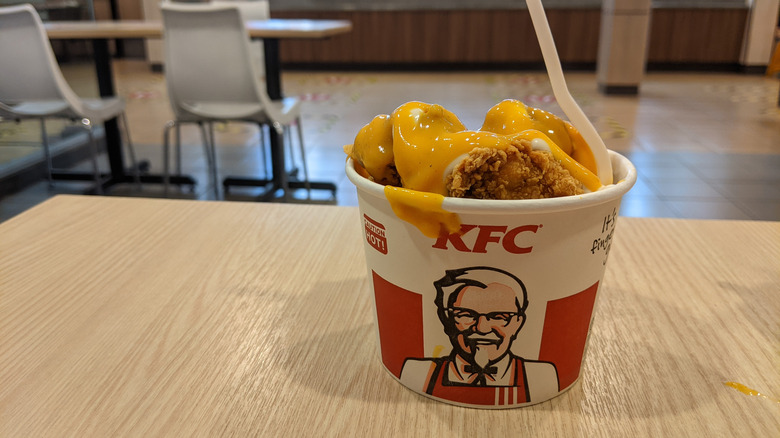 A KFC bowl on a table with a white fork inside