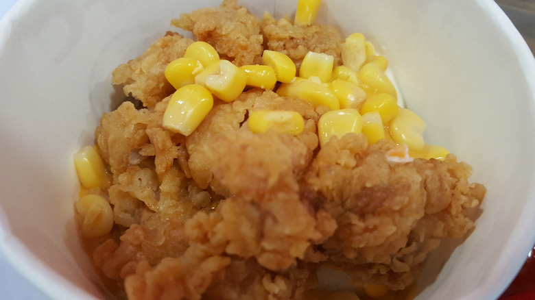 A bowl with KFC chicken chunks and corn