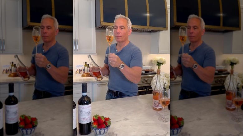 Geoffrey Zakarian holding wine