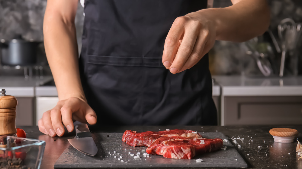 Sprinkling salt on steak