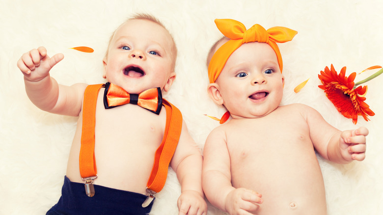 Two adorable babies in fall themed outfits