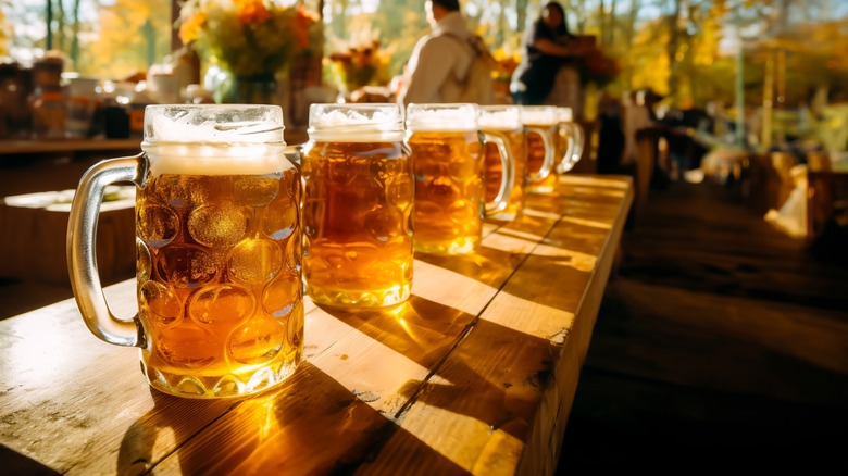 Mugs of beer on table