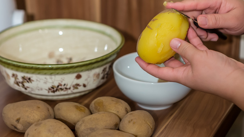 Person prepares potato salad