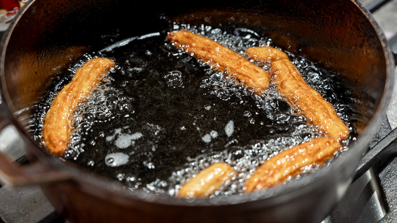 churros frying in hot oil