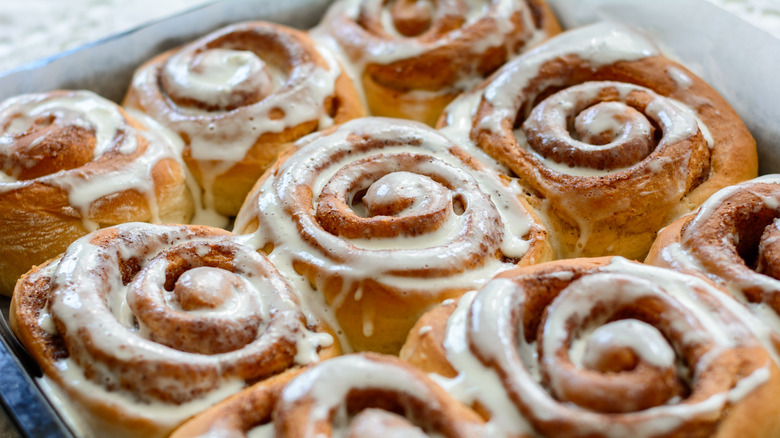 pan of iced cinnamon rolls