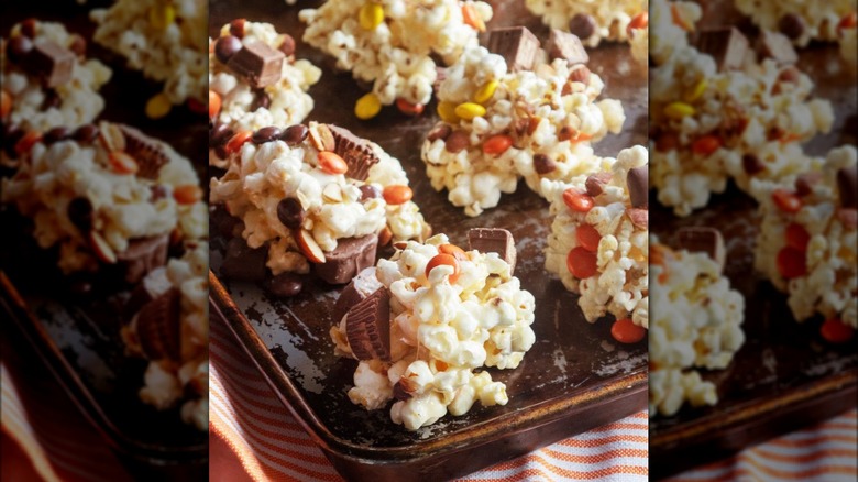 Giada De Laurentiis's popcorn clusters recipe with reese's peanut butter cups and yellow, orange and brown M&Ms
