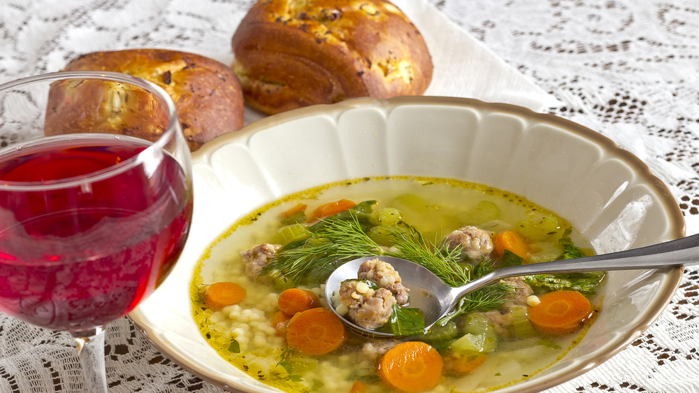 Italian wedding soup with bread and wine 