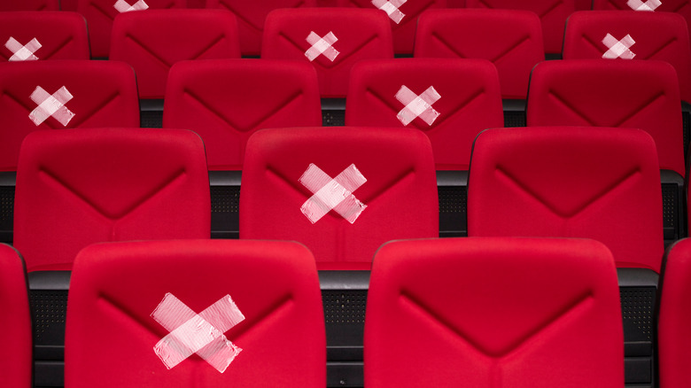 Rows of red chairs with x's to indicate social distancing