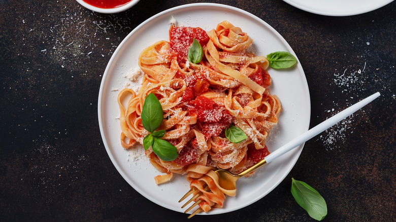 Bowl of pasta with marinara sauce and fork