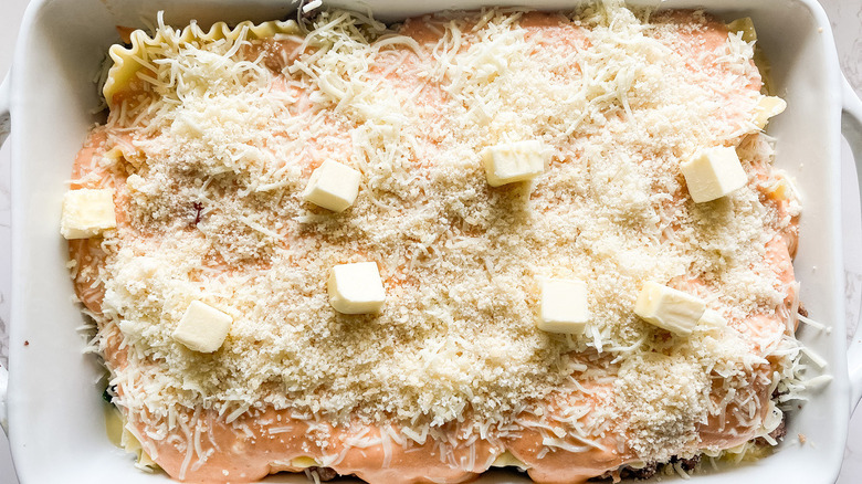 uncooked lasagna in baking dish