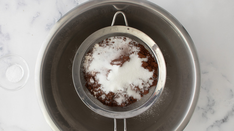 sifting dry ingredients into bowl