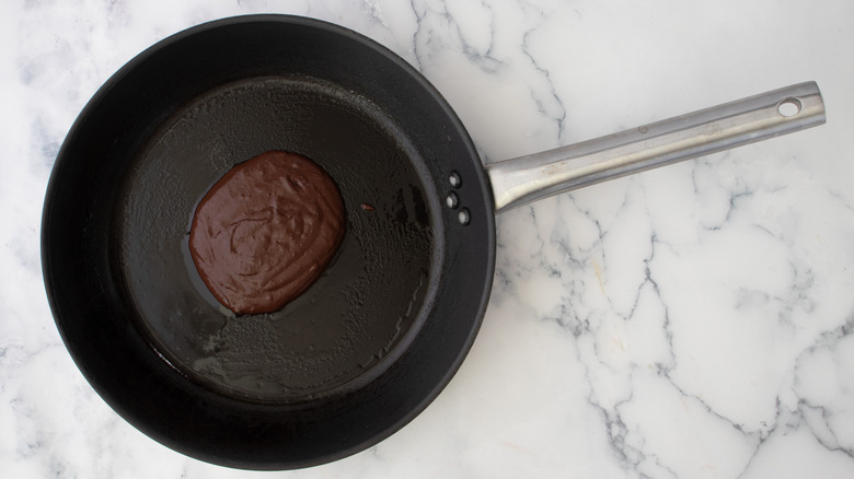 pancake batter scoop in skillet