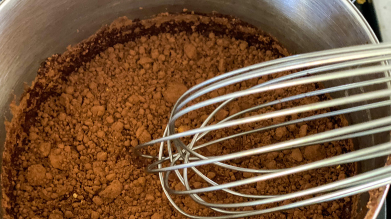 whisk and cocoa in pot 