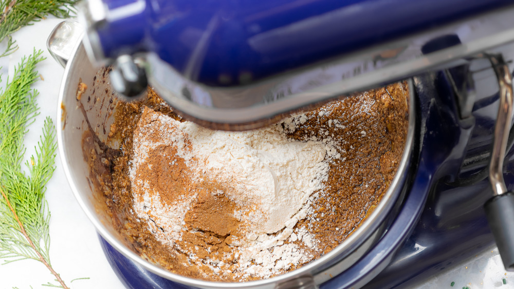 adding the dry ingredients to make gingerbread house dough