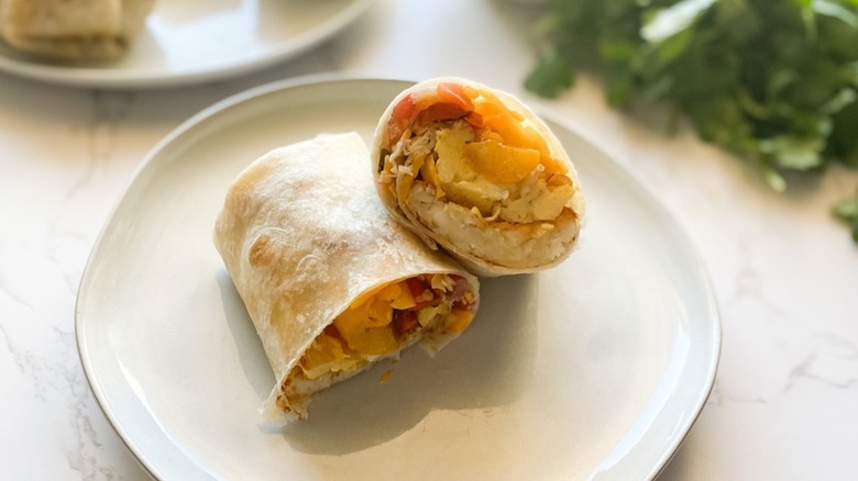 A breakfast burrito sliced in half