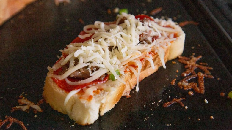 Bread with cheese toasting on griddle