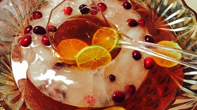 Cranberry and orange punch in glass bowl with ice ring