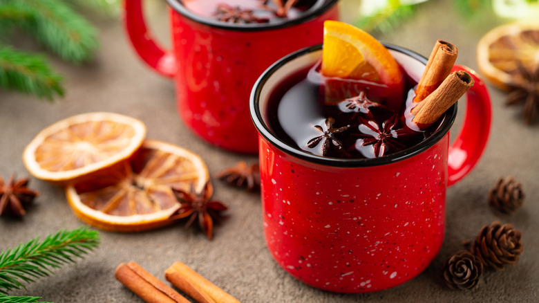 two red mugs with wine and spices