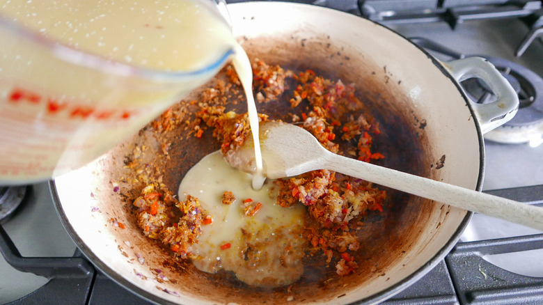 broth pouring into skillet