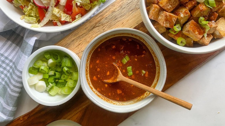 reddish condiment in white bowl