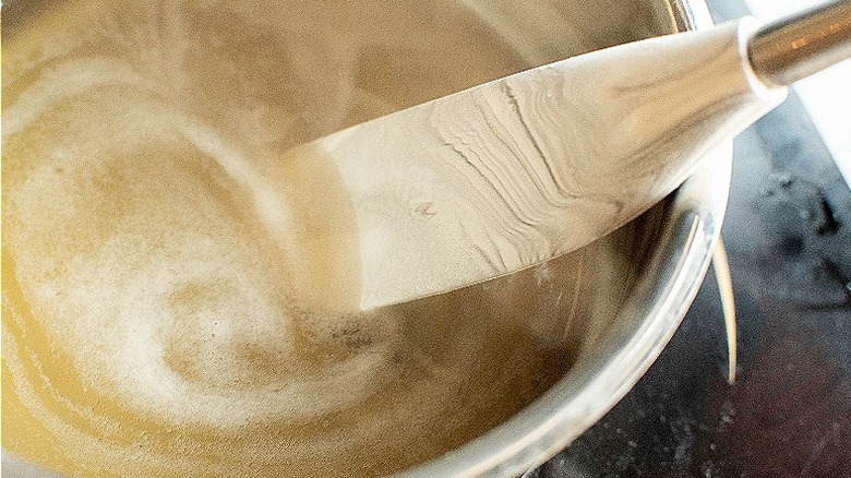 spatula stirring honey and water