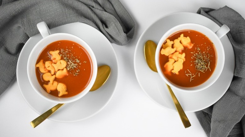 cups of tomato soup with goldfish and penguins crackers