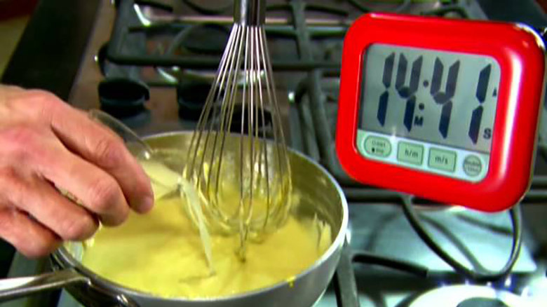 Eggs benedict whisking in bowl