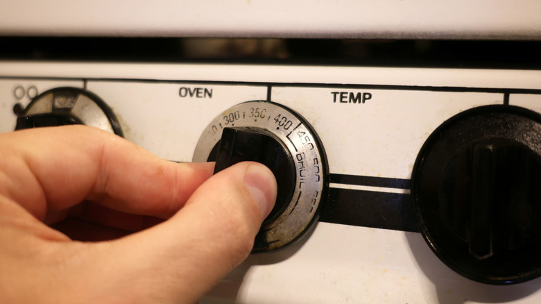 Fingers on oven dial