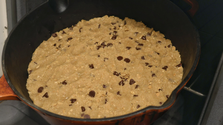 Skillet of cookie dough going into oven