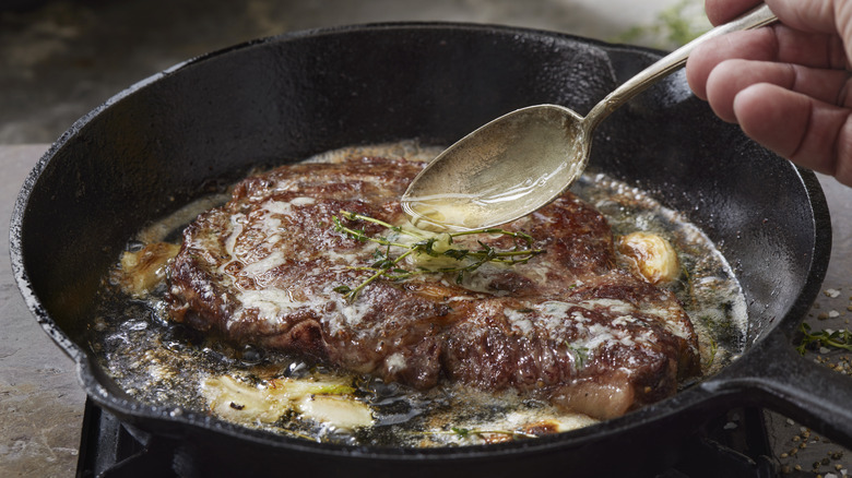 Basting steak in skillet