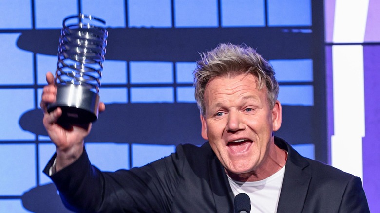 Gordon Ramsay holding metal cup