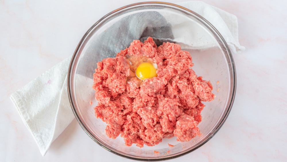 mixing ground beef for Gordon Ramsay's burger recipe with a twist