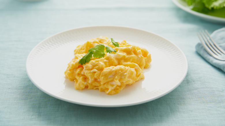 plate of scrambled eggs with fork