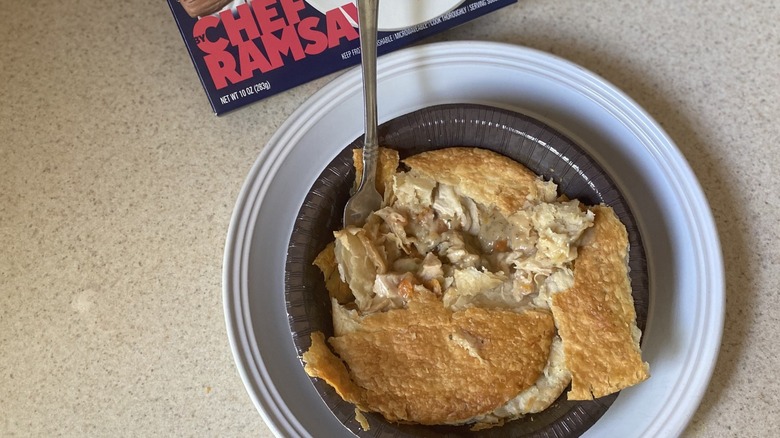 Half-eaten chicken pot pie with fork