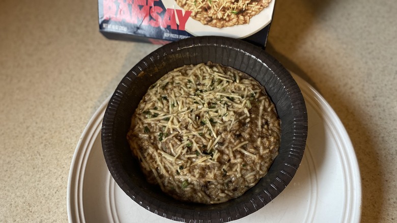 Heated mushroom risotto meal on white plate