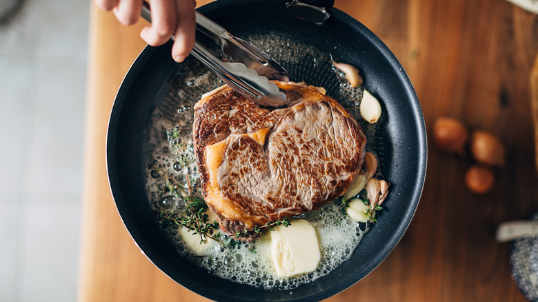 Searing steak in buttered pan