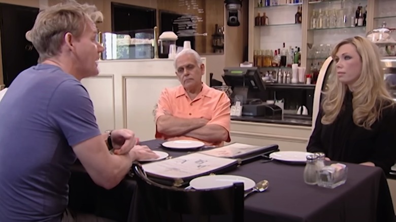 Gordon Ramsay sits at table with man and woman
