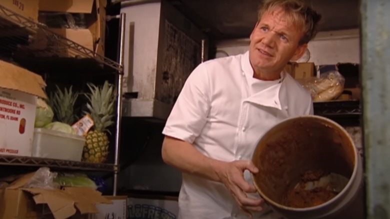 Gordon Ramsay holds up tub of food