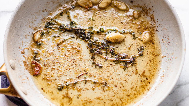 herbs garlic and butter in pan