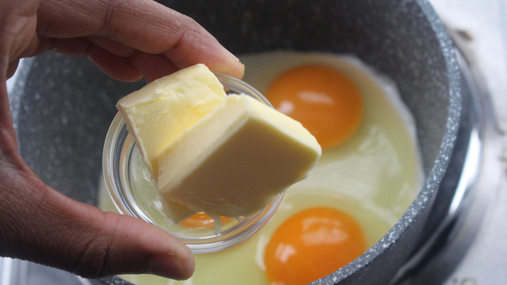 eggs and butter on stove for Gordon Ramsay's scrambled eggs with a twist