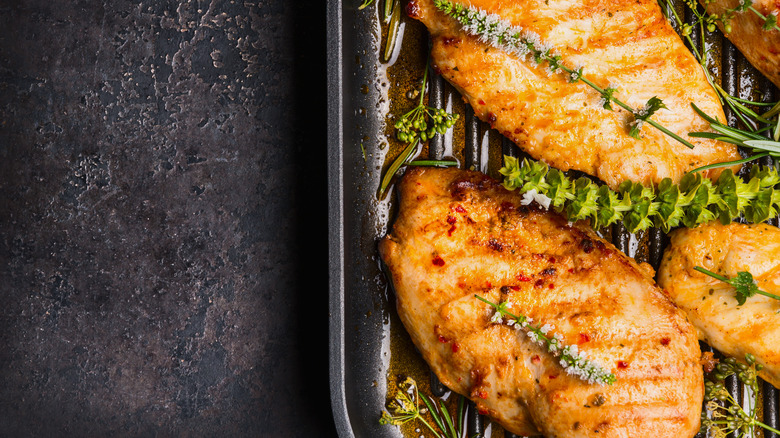 chicken breasts basting in butter with herbs