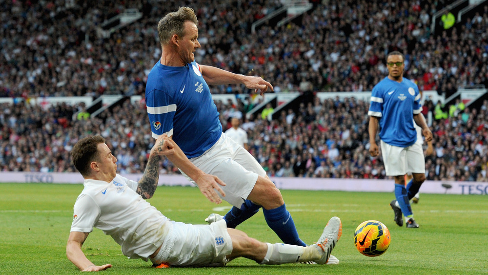 Danny Jones of England tackles Gordon Ramsay of the Rest of the World during Soccer Aid 2014