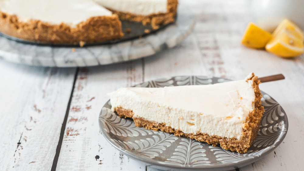 No-bake cheesecake on gray and white plate on wood surface