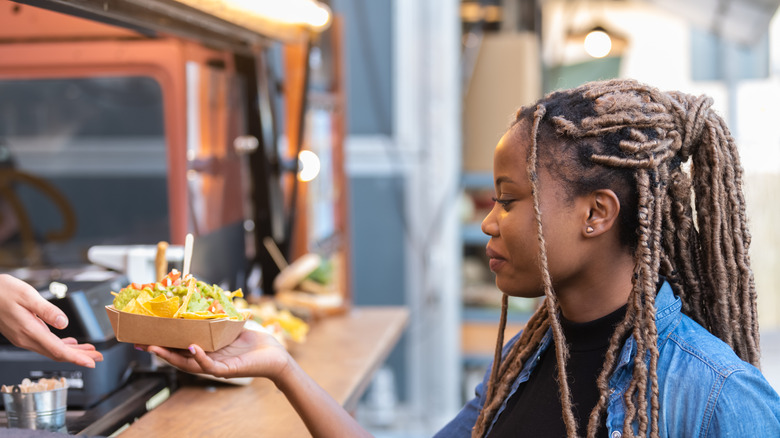 Woman with food truck nachos