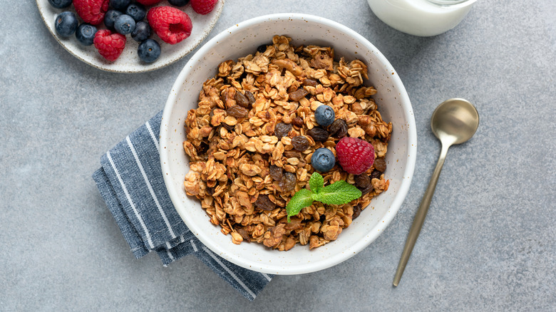 A bowl of granola with blueberries and raspberries 