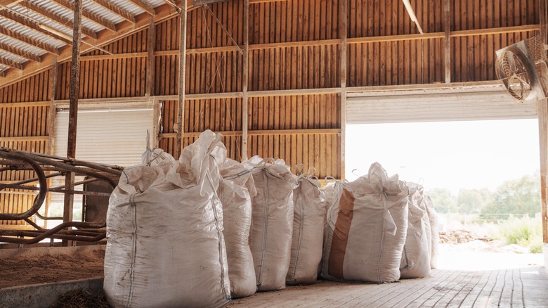 large bags of grain in rustic barn