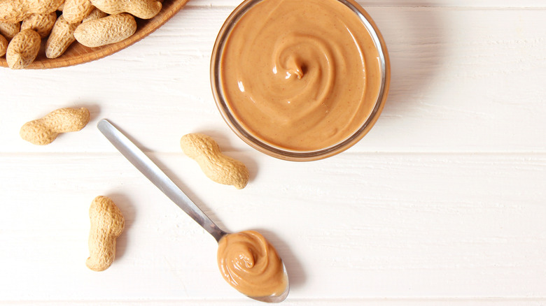 A bowl and spoon of peanut butter