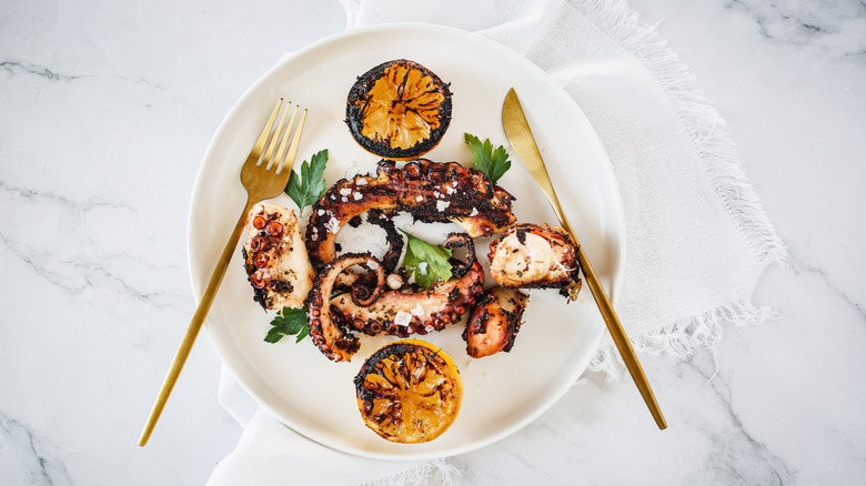 octopus and lemons on plate