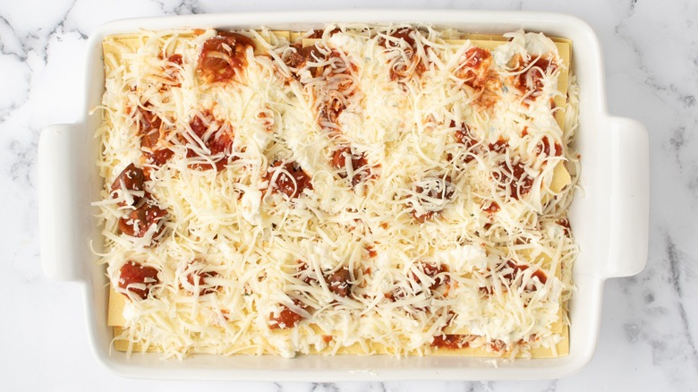 uncooked lasagna in casserole dish