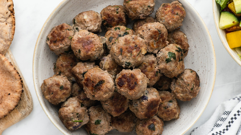 cooked greek meatballs in bowl 